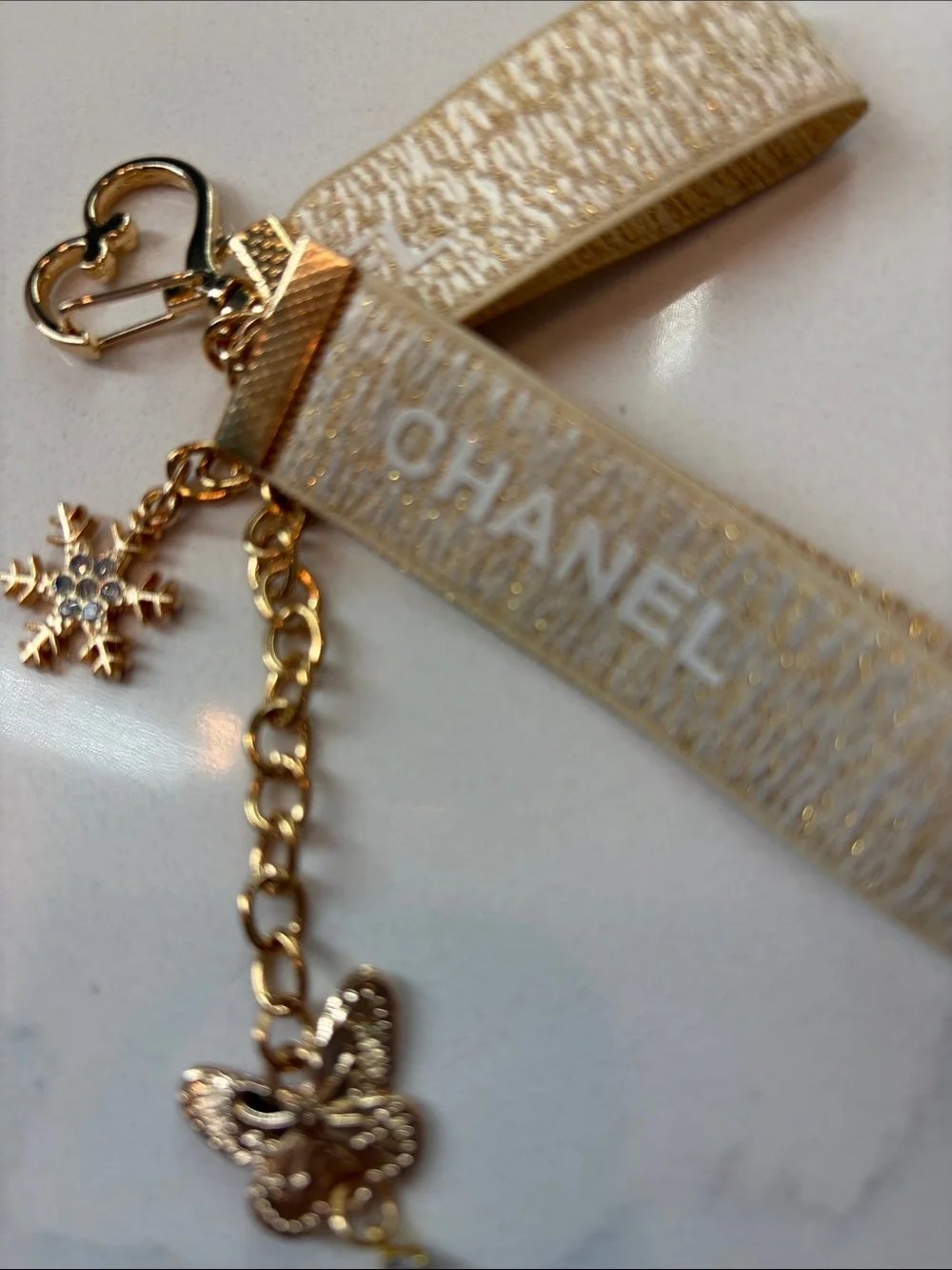 Beige and Gold Logo Strap Keychain with Charms